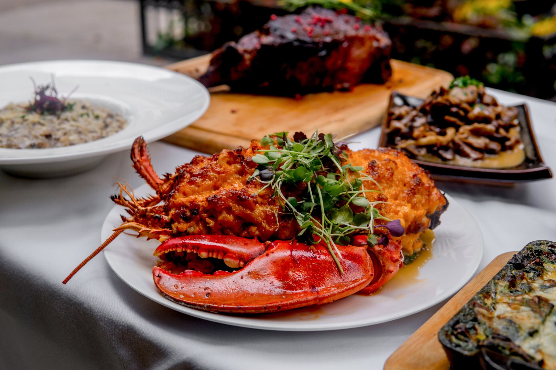 Lobster main course surrounded by steakhouse side dishes