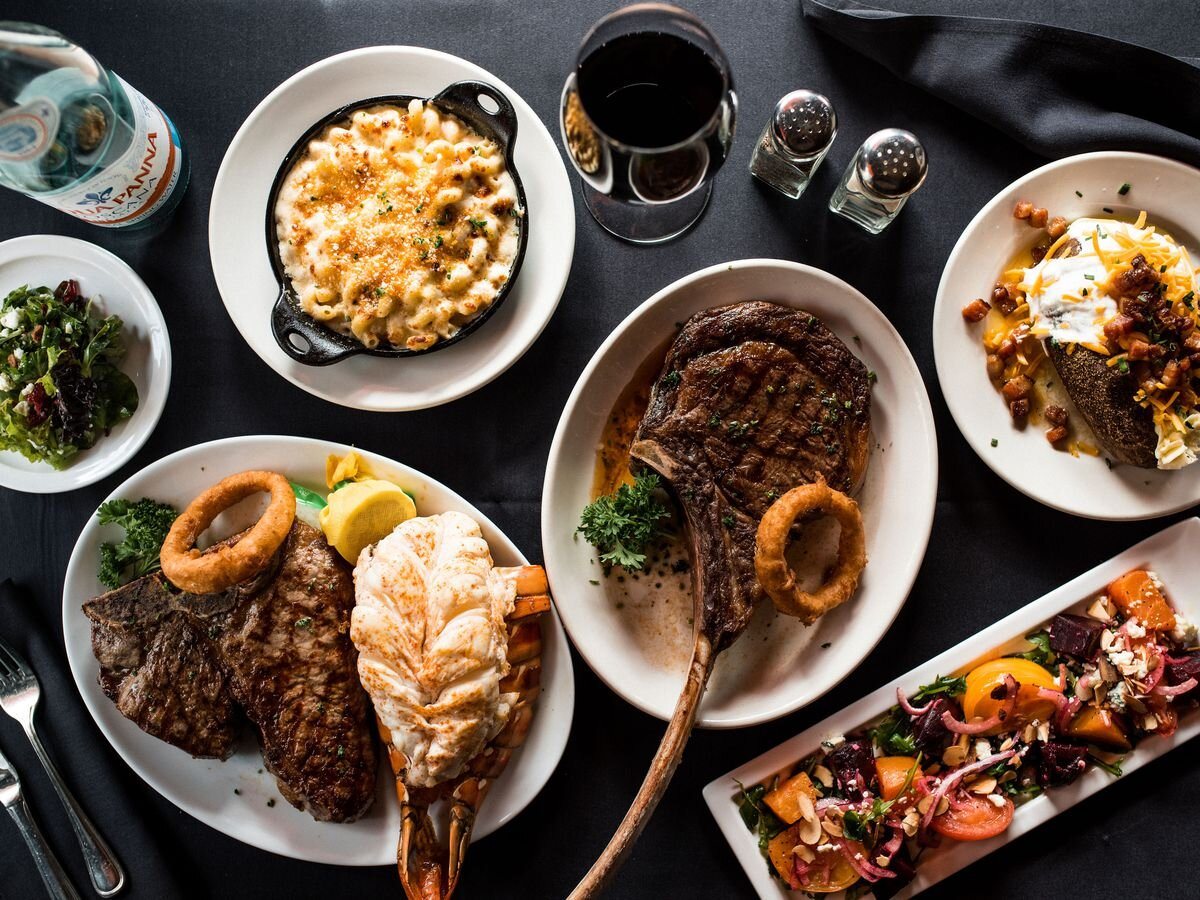Steakhouse table spread at 212 Steakhouse