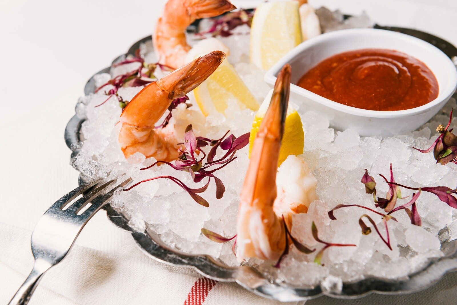 Wild shrimp cocktail served on crushed ice with cocktail sauce